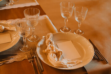 A beautifully arranged table with exquisite glassware, fine plates, and detailed napkins for exceptional dining