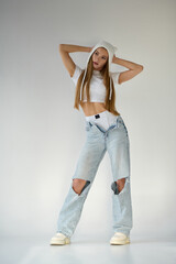 Stylish young woman in ripped jeans and crop top. hip hop style