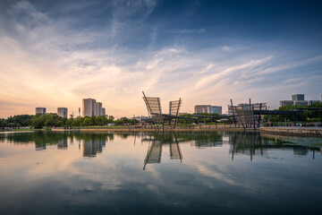 Naklejka premium Modern City Skyline at Sunset Reflected on Water