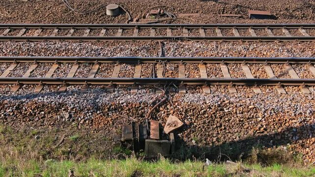 Parallel Railway Track with Electric Cables and Train Sensor on Crushed Rock Ballast