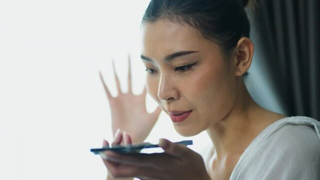 Asian woman uses telephone for complain after opening carton box, received online shopping parcel wrong product order from retails store,  She wants to return package.