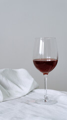A glass of red wine on a white tablecloth