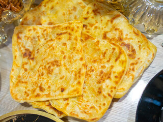 Golden Flatbreads on Wooden Table Perfect for Sharing