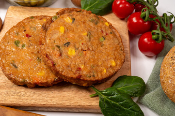 Round vegetarian patties or burgers made from grains, soybeans, vegetables and legumes