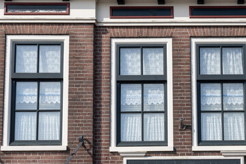 Tourists destination in North Holland, old authentic fishermen village Volendam near Amsterdam with old houses and narrow streets