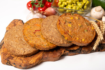 Round vegetarian patties or burgers made from grains, soybeans, vegetables and legumes