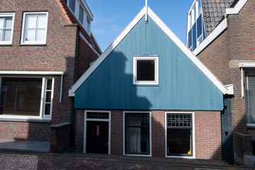 Tourists destination in North Holland, old authentic fishermen village Volendam near Amsterdam with old houses and narrow streets