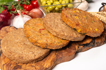 Round vegetarian patties or burgers made from grains, soybeans, vegetables and legumes