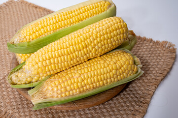 Fresh yellow ripe sweet raw corn, sugar corn or pole corn, variety of maize, uncooked