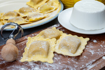 Italian food, fresh home made stuffed pasta ravioli dumplings with ricotta soft cheese and champignons porcini mushrooms, Parma, Emilia Romagna, Italy
