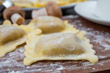 Italian food, fresh home made stuffed pasta ravioli dumplings with ricotta soft cheese and champignons porcini mushrooms, Parma, Emilia Romagna, Italy