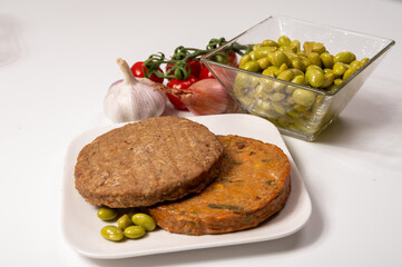 Round vegetarian patties or burgers made from grains, soybeans, vegetables and legumes