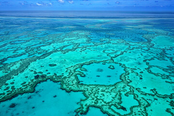 Aerial view of part of the Great Barrier Reef, the world's largest coral reef system composed of...