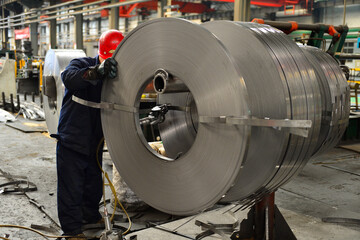 Workers on the production line of the strip steel coil factory are working