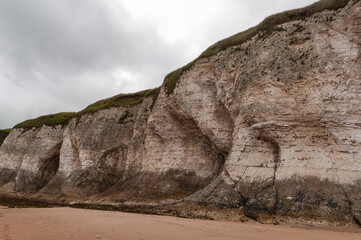A rocky cliff with a white and gray color