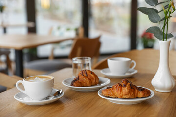 Delicious breakfast served on wooden table in cafe