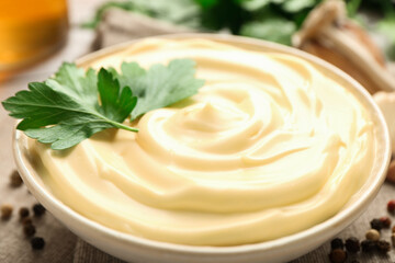 Delicious mayonnaise sauce with parsley in bowl on table, closeup