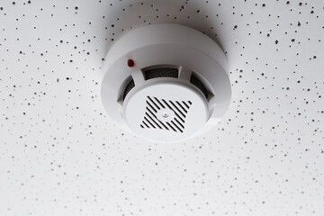 Smoke detector on light textured background. Alarm system