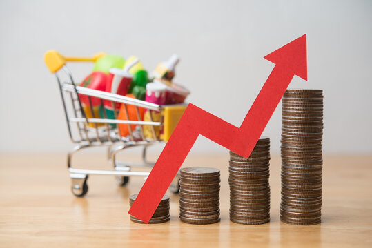 Red arrow growth chart and stack coins with food, drinks, vegetables, fruits in supermarket trolley. Rising cost of living, food price increase, inflation crisis, war effect to global economic concept