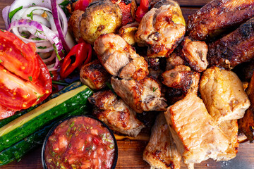 Grilled meat platter served with fresh vegetables and salsa