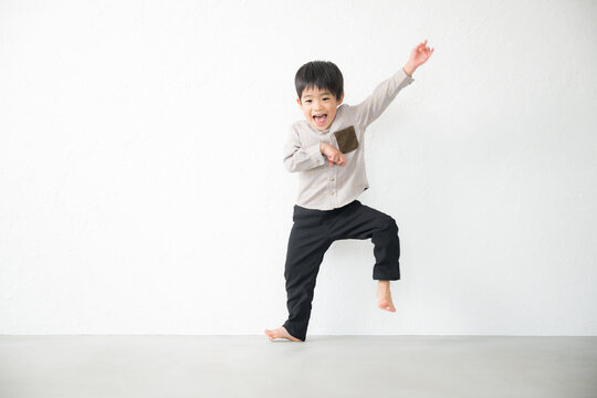 Toddlers happily dancing, stretching, using their bodies for exercise, etc. Kids emitting joy with their whole body.