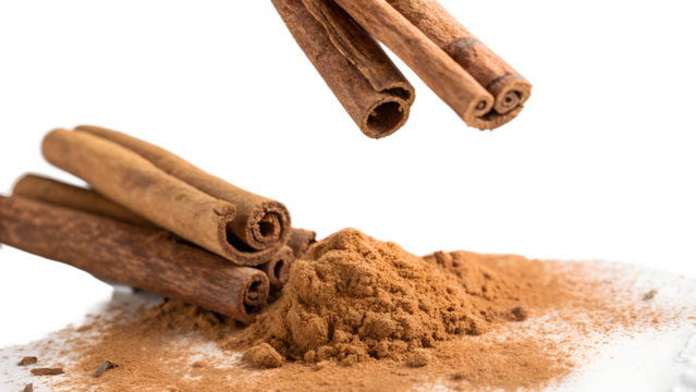 floating cinnamon sticks with powder on white background