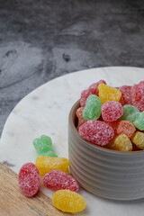 Colourful and tasty sour candies in a bowl.