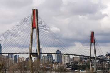 Skytrain Bridge Over River in New Westminster, Vancouver, BC, Under Cloudy Sky