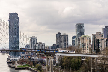 Elevated Train Passing Through Urban Skyline in Vancouver, BC on an Overcast Day