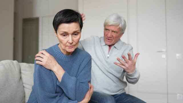Frightened sorrowful wife cant stand enraged unstable husband shouting waving hands. Woman almost crying, suffering domestic abuse, psychological manipulation, toxic family distress, toxic marriage