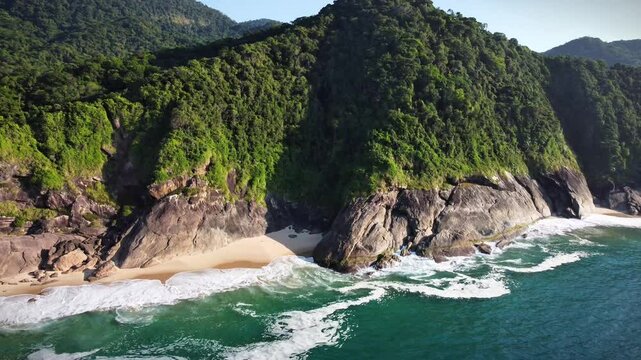 aerial view of the coastline of Paraty in Rio de Janeiro in the summer. It shows the Atlantic Forest and the blue bay