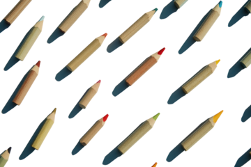 A flat lay of various pencils in different colors neatly arranged on a white surface, creating a grid-like pattern with some pencils slightly tilted and others perfectly aligned