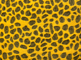 Close up of a graphic background with leopard skin pattern in yellow and black color. Animal skin leopard texture seamless background.