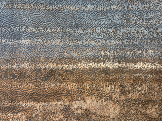 Graphic background in abstract illustrated cloud, brushed, and wavy pattern. Painted in blue, brown, grey, and beige color. Random grunge and dirt carpet rug seamless background texture
