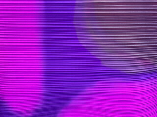 Colorful fabric in purple, magenta, and violet color. With textured fluted horizontal stripes silk linen. Suitable for wallpaper, upholstery, and fabric cloth. Seamless background texture.