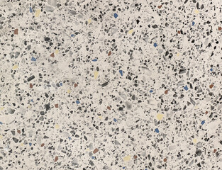 Close up of colorful white terrazzo granite tiles texture. Terrazzo is increasingly being used in contemporary edgy and stylish interior as wall or floor finishing.