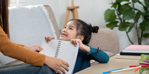 Joy and Accomplishment. A girl excitedly reveals her work during study time.