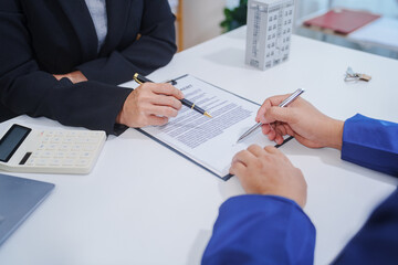 Asian landlord, realtor man pointing on paper for sign signature contract with tenant rental or...