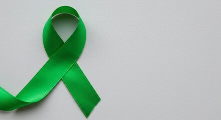 Green Awareness Ribbon on White Background: Symbol of Support and Solidarity for Mental Health, Environmental Causes, and Various Other Initiatives