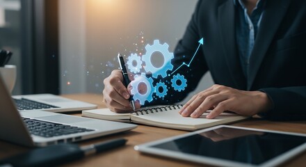 Businessperson planning strategic growth and development, writing in notebook with glowing gear mechanism and upward arrow graphic overlay