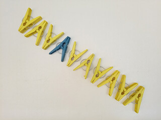 Clothes pins in a diagonal line, plastic laundry clips or clothes pegs in a line on the white background