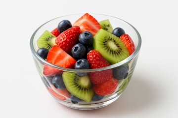 Fruit salad in a glass bowl, with strawberries, blueberries, and kiwi