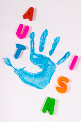 Blue kid handprint made of paint. White background. Autism spectrum disorder