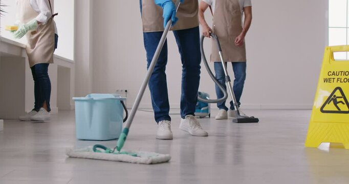 Cleaning service, workers make house chores cleaning home, office floor with mop, doing routine home daily work using broom, professional vacuuming, housekeeping specialist job, caution wet floor sign