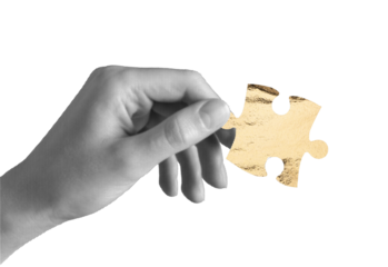 Hand holding one puzzle piece. Golden jigsaw element symbolizing idea, finance, business investment, contribution, success and opportunity, wealth. Isolated on white background..