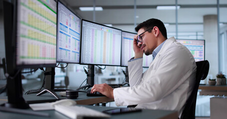 Unhappy Medical Doctor Doing Spreadsheet Codes