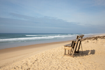 wooden bench sand along sea atlantic ocean beach le grand crohot in lege cap-ferret in french coast
