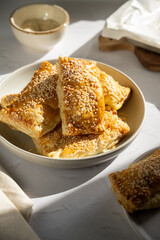 Close-up puff pastries with cottage cheese and sesame seeds
