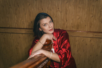 Fototapeta premium Young woman in red pajamas at home