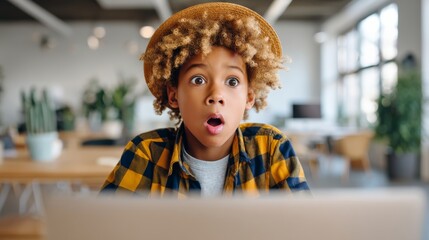 Surprised cute kid staring at laptop screen in office. Copy space --chaos 25 --ar 16:9 --profile muwoyfp --v 7 Job ID: 5e5bbcaf-a15c-4edb-b635-c7d726ed551b